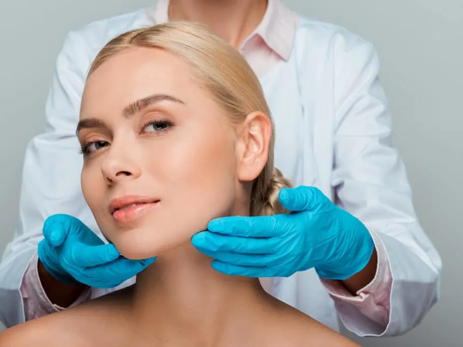 Woman and dermatology professional showing off glowing skin after microneedling treatment.