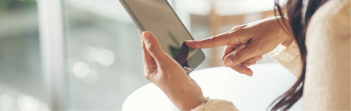 A person pointing at a tablet screen — a stock picture