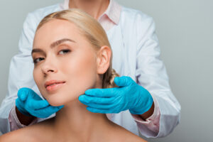 Woman and dermatology professional showing off glowing skin after microneedling treatment.